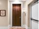 View of the condo entrance featuring a solid wood door at 7600 Landmark Way # 904, Greenwood Village, CO 80111