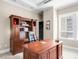 Inviting home office with a large wooden desk, hutch, and natural light from the window at 7600 Landmark Way # 904, Greenwood Village, CO 80111