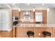 Modern kitchen with a large island, stainless steel appliances, and wooden cabinets at 7600 Landmark Way # 904, Greenwood Village, CO 80111