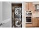 A laundry area with stacked washer/dryer units, cabinetry, and shelving for storage solutions at 7600 Landmark Way # 904, Greenwood Village, CO 80111