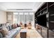 Open living room with large windows and a gray sofa at 7600 Landmark Way # 904, Greenwood Village, CO 80111