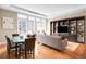 Bright living room with hardwood floors, large windows, a dining area, and custom built-in shelving at 7600 Landmark Way # 904, Greenwood Village, CO 80111