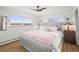 Charming bedroom with a tufted headboard, soft linens, and bright natural light at 2300 Willow Ln, Lakewood, CO 80215