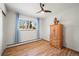 Bright bedroom with a ceiling fan and a charming wooden dresser at 2300 Willow Ln, Lakewood, CO 80215