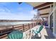 Relax on this spacious deck with stunning waterfront views, perfect for entertaining or enjoying serene sunsets at 2300 Willow Ln, Lakewood, CO 80215