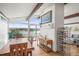 Open dining area with water views, white brick accent, and wood furnishings at 2300 Willow Ln, Lakewood, CO 80215