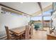 Inviting dining room featuring a large wood table, white brick wall, and scenic view at 2300 Willow Ln, Lakewood, CO 80215