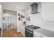 Beautiful kitchen featuring stainless steel appliances, white countertops and cabinets, with a modern range hood at 2300 Willow Ln, Lakewood, CO 80215