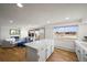 Bright kitchen featuring an island, white cabinets, and a lovely lake view at 2300 Willow Ln, Lakewood, CO 80215