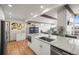 Modern kitchen with large island, stainless steel appliances, and great lighting for cooking and entertaining at 2300 Willow Ln, Lakewood, CO 80215