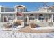 Two-story townhome with snow-covered walkway and landscaping at 1805 W 101St Ave, Thornton, CO 80260