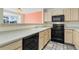 Galley kitchen with black appliances and light cabinets at 1805 W 101St Ave, Thornton, CO 80260