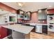 Modern kitchen featuring stainless steel appliances, dark cabinets, island and ample counter space at 3700-3704 Osage St, Denver, CO 80211