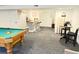 Spacious finished basement featuring a pool table, bar area, and modern gray carpeting at 19987 E Belleview Pl, Centennial, CO 80015