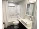 Beautiful bathroom features white marble tile, a modern sink, and a shower-tub combo at 19987 E Belleview Pl, Centennial, CO 80015