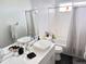 Bright bathroom with double vanity, stylish mirrors, and shower-tub combination at 19987 E Belleview Pl, Centennial, CO 80015