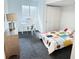 Bright bedroom with a large window, closet, and an interesting quilt on the bed at 19987 E Belleview Pl, Centennial, CO 80015