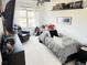 Cozy bedroom with neutral decor, comfortable bed, and relaxing sitting area at 19987 E Belleview Pl, Centennial, CO 80015