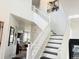 Elegant entryway with staircase, white railing, contrasting dark treads, and modern decor at 19987 E Belleview Pl, Centennial, CO 80015