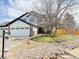 A two-story home with a front yard, stone walkway, and a three-car garage at 19987 E Belleview Pl, Centennial, CO 80015
