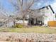 Charming two-story home with a well-maintained yard, stone walkway, and a three-car garage at 19987 E Belleview Pl, Centennial, CO 80015