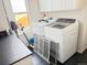 Efficient laundry room with modern washer, dryer, convenient countertops, and ample storage space at 19987 E Belleview Pl, Centennial, CO 80015