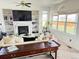 Inviting living room with fireplace, built-in shelves, and large windows at 19987 E Belleview Pl, Centennial, CO 80015