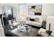 Bright living room with stylish decor, large window, and cozy seating arrangement at 19987 E Belleview Pl, Centennial, CO 80015