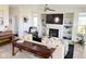 Inviting living room with fireplace, built-in shelves, and connected bathroom at 19987 E Belleview Pl, Centennial, CO 80015