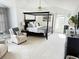 Spacious main bedroom with a canopy bed, sitting area, and ample natural light at 19987 E Belleview Pl, Centennial, CO 80015