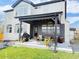 Relaxing outdoor patio with covered area, comfortable seating, and well-maintained lawn at 19987 E Belleview Pl, Centennial, CO 80015