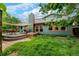 Spacious backyard featuring a well-manicured lawn, deck, hot tub, and mature trees at 3982 Arbol Ct, Boulder, CO 80301