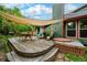 Inviting backyard deck with sail shades, dining area, hot tub, and well-maintained landscaping at 3982 Arbol Ct, Boulder, CO 80301