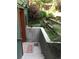 Exterior basement entrance with charming landscape, concrete surround and brick welcome mat at 3982 Arbol Ct, Boulder, CO 80301