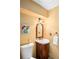Charming half bath features a pedestal sink, wood vanity, decorative mirror, and a toilet at 3982 Arbol Ct, Boulder, CO 80301