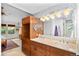 Elegant primary bath boasts double sinks, custom wood cabinets, and decorative tile at 3982 Arbol Ct, Boulder, CO 80301