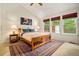 Sunlit bedroom boasts three large windows, a vaulted ceiling, and a comfortable bed at 3982 Arbol Ct, Boulder, CO 80301