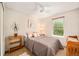 Bright bedroom featuring a neutral color scheme, ceiling fan, and a large window providing natural light at 3982 Arbol Ct, Boulder, CO 80301