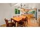 Dining room with large table and chairs adjacent to a well-lit kitchen at 3982 Arbol Ct, Boulder, CO 80301