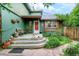 Charming front porch with welcoming bench, serene Buddha statue, and lush garden at 3982 Arbol Ct, Boulder, CO 80301