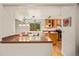 Open kitchen and dining area with wood floors, granite countertops, and a large window with a view at 3982 Arbol Ct, Boulder, CO 80301