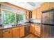 Bright kitchen features wood cabinets, granite countertops, stainless steel appliances, and a large window at 3982 Arbol Ct, Boulder, CO 80301