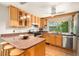 Bright kitchen features wood cabinets, granite countertops, stainless steel appliances, and a large window over the sink at 3982 Arbol Ct, Boulder, CO 80301
