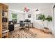 Functional office space featuring a colorful ceiling fan, desk setup, and large floral area rug at 3982 Arbol Ct, Boulder, CO 80301