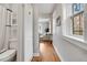 Clean hallway with hardwood floors and access to bathroom and living area at 1341 N Washington St # 4, Denver, CO 80203
