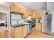 Bright kitchen, stainless steel appliances, wood cabinets at 1341 N Washington St # 4, Denver, CO 80203