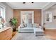 Living room featuring exposed brick wall, hardwood floors, and comfortable seating at 1341 N Washington St # 4, Denver, CO 80203