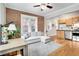 Open living room with exposed brick, hardwood floors, and L-shaped sofa at 1341 N Washington St # 4, Denver, CO 80203