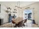 Kitchen dining area with a wooden table, sliding door, and modern light fixture at 7120 Clarke Dr, Frederick, CO 80530