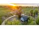 Aerial view of the property featuring various outbuildings, silos, and green pastures at 13183 N 95Th St, Longmont, CO 80504